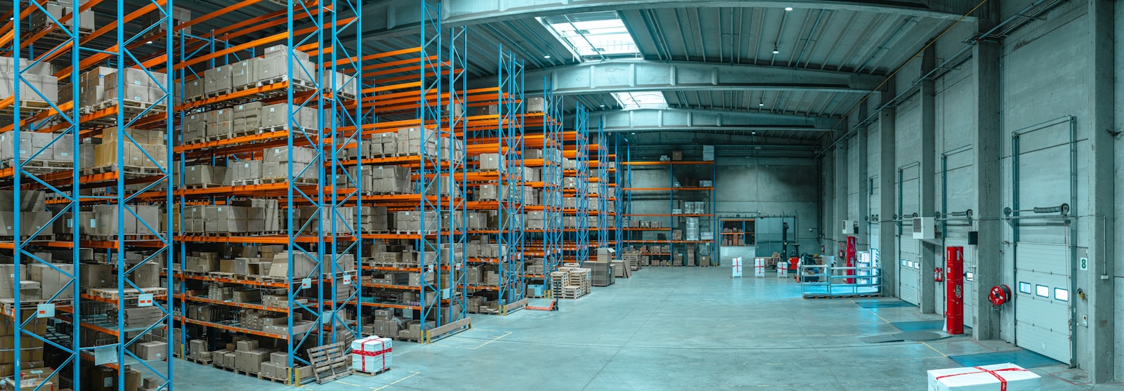 Warehouse loading bay with pallets and forklift